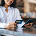Woman paying with card on phone